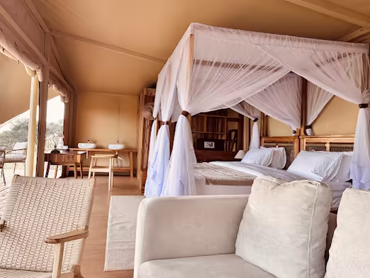 Canopy bed with a mosquito net in a tented suite