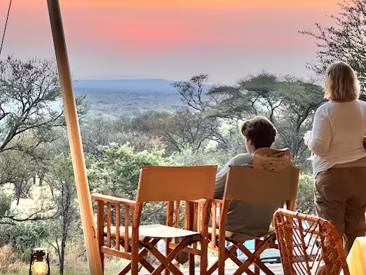 Guests on the deck watching the sun go down over the valley