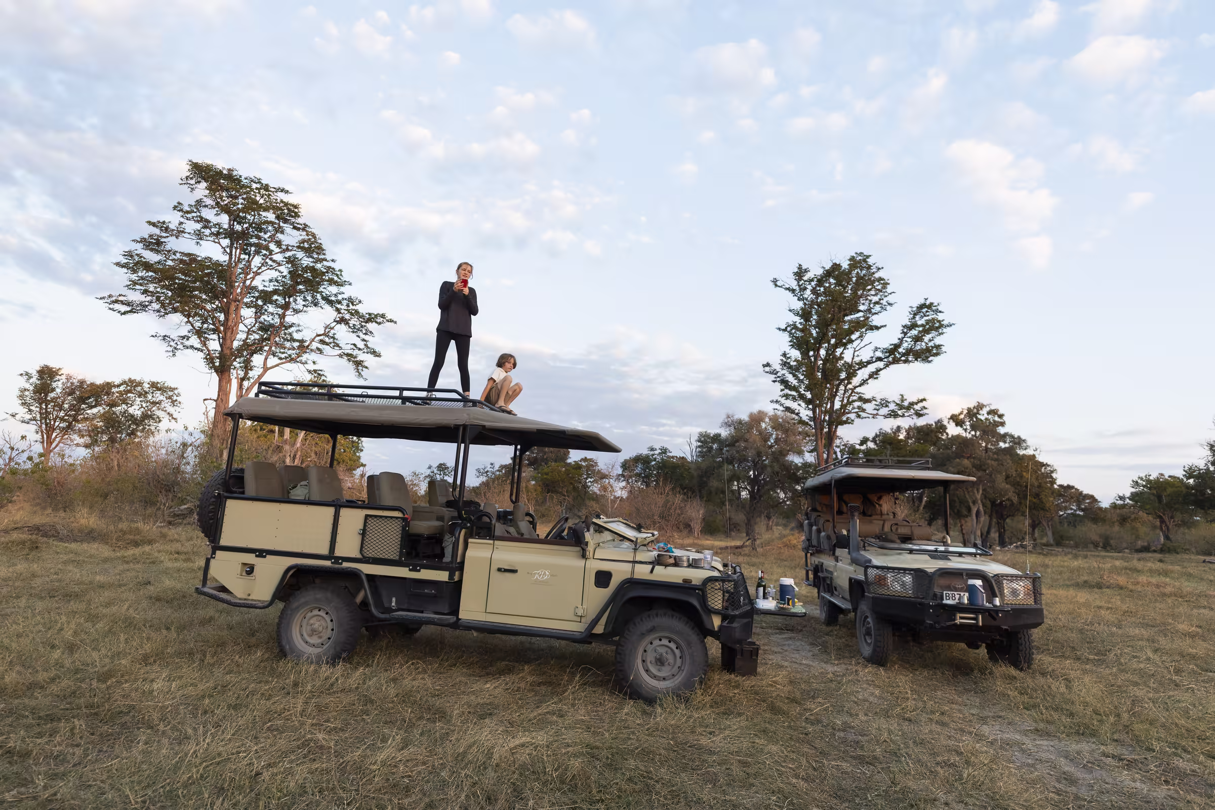 Two children on the roof of a safari vehicle